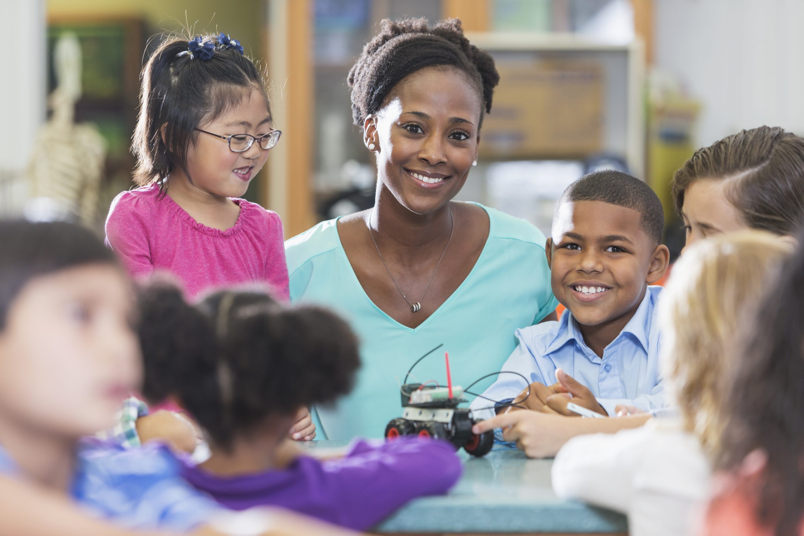 African American teacher with diverse young students